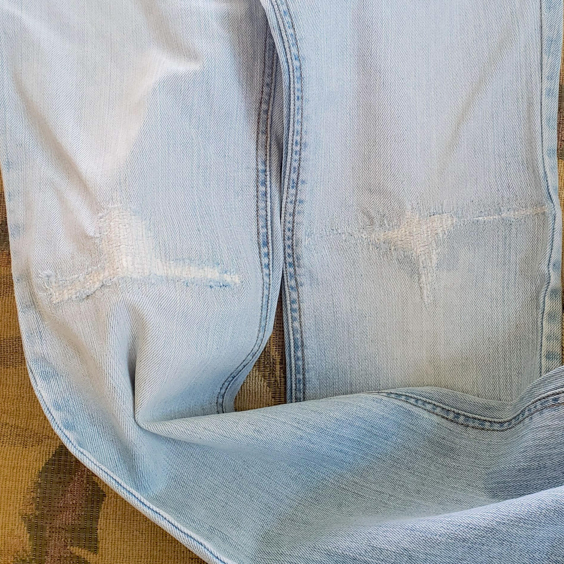 Ripped knees in jeans come out stronger after mending